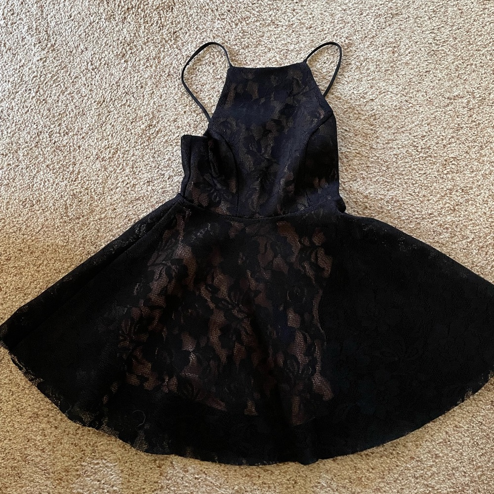 small black halter dress with straps, has beige underlining and black lace over